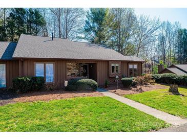 Inviting single story home with brown siding, stone accents, manicured lawn and walkway to the front door at 1713 12Th Ne St, Hickory, NC 28601