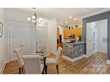 Bright dining area with a glass table and comfortable chairs near the kitchen at 2934 Selwyn Ave, Charlotte, NC 28209