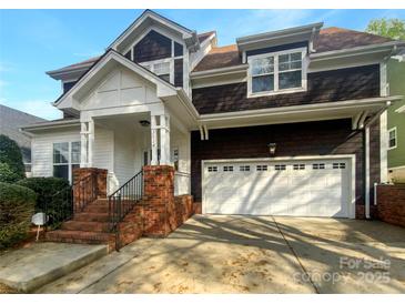 Charming two-story home featuring a brick staircase leading to the covered porch and a two-car garage at 3114 Parker Green Trl, Charlotte, NC 28269