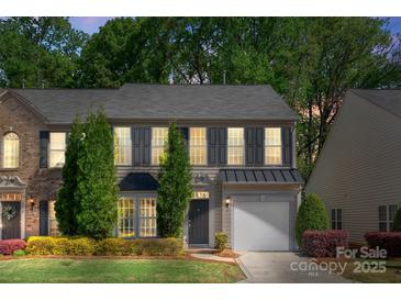 Charming two-story home with well-maintained landscaping, shutters, and an attached garage in a tree-lined neighborhood at 3214 Park South Station Blvd, Charlotte, NC 28210