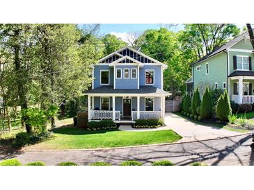 Charming two-story home featuring a welcoming front porch and beautifully landscaped front yard at 420 Solomon St, Charlotte, NC 28216