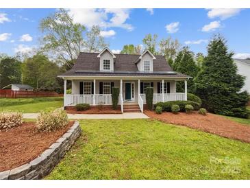 Charming home featuring a welcoming front porch, lush lawn, and beautiful landscaping at 4222 Mt Gallant Rd, Rock Hill, SC 29732