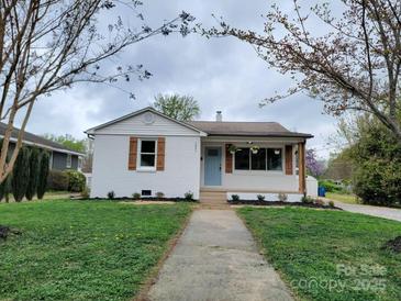 Charming single-story home with a tidy front lawn and inviting light blue entry door at 1421 Van Nuys St, Salisbury, NC 28144