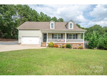 Charming home with a covered front porch, two-car garage, and beautifully landscaped yard at 1812 Sam Smith Rd, Fort Mill, SC 29708