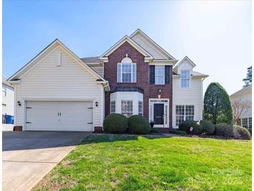 Charming two-story home featuring a well-manicured lawn and attached two-car garage at 20132 Tailwind Ln, Cornelius, NC 28031