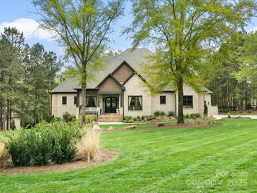 Stately brick home on a lush green lawn, featuring an inviting entrance and mature trees at 4012 Flagstone Dr, Lancaster, SC 29720