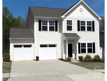 Charming two-story home features a two-car garage, well-maintained lawn, and classic architectural details at 5109 Arbordale Way, Mount Holly, NC 28120