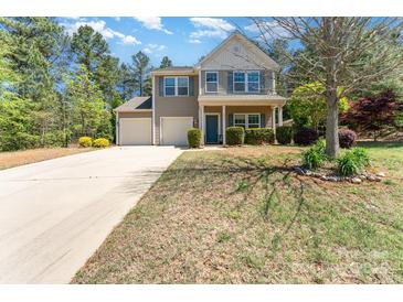 Charming two-story home with a two-car garage, lovely landscaping, and a welcoming front porch at 6010 Hawk View Rd, Waxhaw, NC 28173