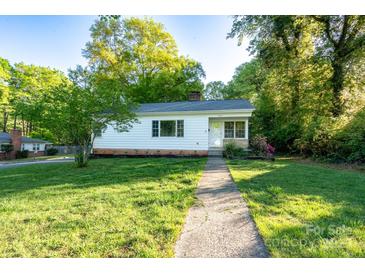 Charming home featuring a well-maintained lawn and inviting walkway up to the front door at 676 Forest Nw St, Concord, NC 28025