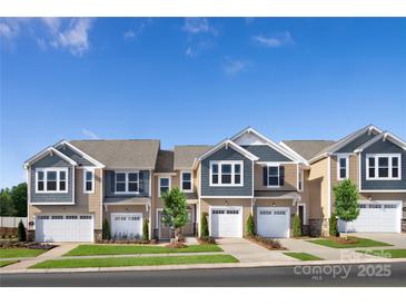 Charming townhomes featuring attached garages, neutral color schemes, and well-manicured lawns at 7204 Hodges Meadow Ln, Charlotte, NC 28213