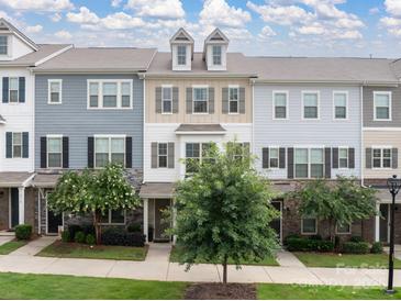 Charming multi-story townhomes featuring neutral siding and manicured landscaping, with inviting curb appeal at 9710 Ainslie Downs St, Charlotte, NC 28273