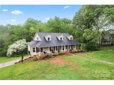 Stunning aerial view of the home with a lush lawn, mature trees, and inviting front porch at 109 Windmill Rd, Salisbury, NC 28147