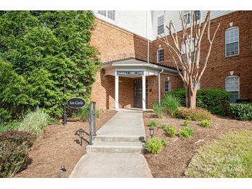 Inviting brick building entrance featuring well-manicured landscaping and clearly marked signage at 14849 Santa Lucia Dr, Charlotte, NC 28277