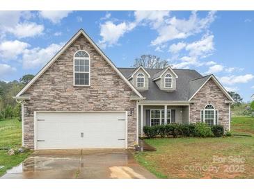 Charming home featuring a stone and vinyl exterior, attached two-car garage, and well-maintained landscaping at 2408 Joes Lake Rd, Shelby, NC 28152