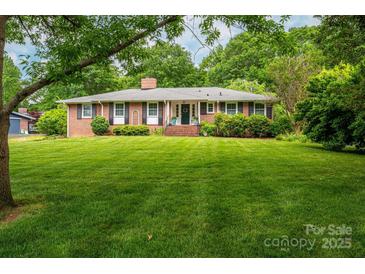 Charming brick home with well-manicured lawn and mature landscaping providing great curb appeal at 2515 Sheffield Dr, Gastonia, NC 28054