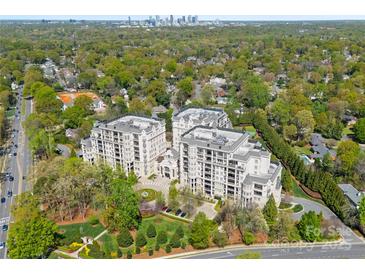 Stunning aerial view of luxurious condos surrounded by lush greenery, with Charlotte skyline in the distance at 2823 Providence Rd # 143, Charlotte, NC 28211