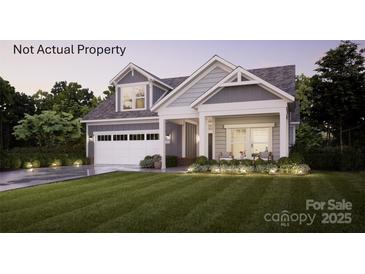 Charming two-story home with a manicured lawn, inviting porch, and integrated two-car garage at 39 Five Creek Rd # 39, Charlotte, NC 28213