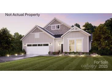 Charming single-Gathering home featuring a modern facade, lush lawn, and a two-car garage at 47 Creek Bridge Cir # 47, Charlotte, NC 28213