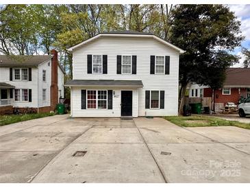 Charming two-story home with black shutters and a spacious concrete driveway at 4927 Curtiswood Dr, Charlotte, NC 28213