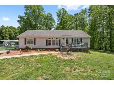 Charming ranch-style home features a well-maintained lawn, inviting front porch, and a carport at 1756 Martin Rd, Kings Mountain, NC 28086
