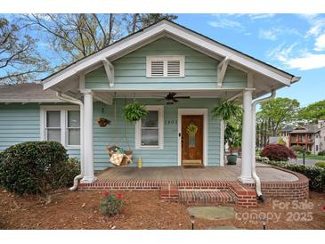 Charming covered front porch with swing, hanging plants, and traditional architectural details at 1801 Wilmore Dr, Charlotte, NC 28203