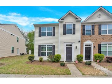 Two-story townhome featuring black shutters and a well-manicured lawn at 1828 Aston Mill Pl, Charlotte, NC 28273
