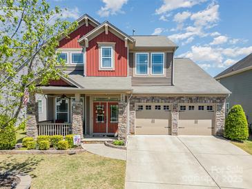 Charming two-story home with stone accents, a front porch, and a three-car attached garage at 190 Silverspring Pl, Mooresville, NC 28117