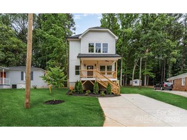 Charming new construction home with a covered front porch and lush green lawn at 2512 Remington St, Charlotte, NC 28216