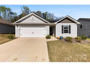 Charming single-story home with a well-maintained lawn, a two-car garage and welcoming curb appeal at 3118 Maple Ridge Dr # 11, Gastonia, NC 28052