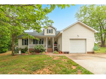 Charming home featuring a welcoming front porch, one car garage, and a well-maintained lawn with mature landscaping at 3790 Lynnview Ct, Maiden, NC 28650