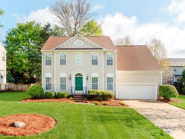 Charming two-story home featuring a well-manicured lawn, a green front door, and an attached two-car garage at 431 Harvest Ter, Lake Wylie, SC 29710