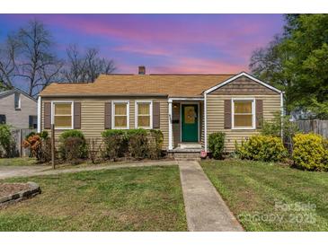 Charming single-story home featuring a cozy front porch, well-maintained landscaping, and a lush green lawn at 665 Melbourne Ct, Charlotte, NC 28209