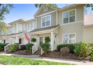 Inviting two-story townhouse with a cozy porch and well-maintained landscaping at 7910 Camden Hollow Rd, Huntersville, NC 28078