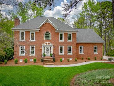 Beautiful two story brick home with mature landscaping and classic architectural details at 1176 Fawn Ridge Nw Rd, Concord, NC 28027