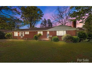 Charming one-story brick home with a well-manicured lawn and mature trees at 1315 Arbor Dr, Salisbury, NC 28144
