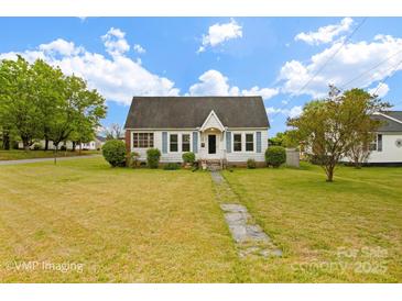 Charming single-story home featuring a well-manicured lawn, classic shutters, and inviting front walkway at 203 Ackert Ave, Salisbury, NC 28144