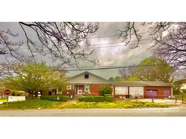 A charming brick home featuring a well-maintained front yard and inviting curb appeal at 204 Lloyd St, Salisbury, NC 28144