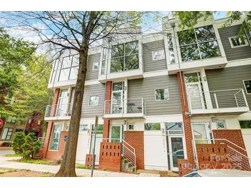 Modern townhome with gray siding, brick accents, and large windows at 2094 Euclid Ave, Charlotte, NC 28203