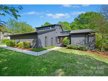 Stunning contemporary home with a well-manicured lawn and beautiful landscaping at 3103 Lauren Glen Rd, Charlotte, NC 28226