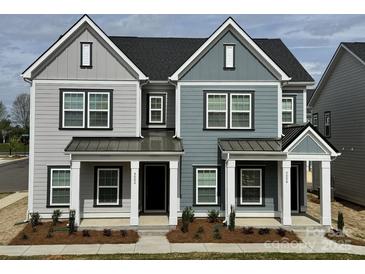 Charming townhome featuring stylish two-tone exterior, modern windows, and inviting covered entry at 4004 Crooked Spruce Ct, Matthews, NC 28105