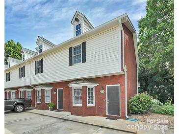 Charming townhome featuring brick and siding exterior with dormer windows and well-maintained landscaping at 405 N Wilson St # 101, Rock Hill, SC 29730