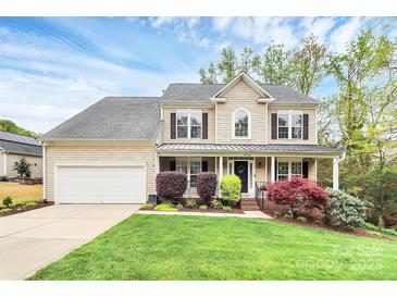 Charming two-story home with a welcoming front porch and well-manicured landscaping and an attached two-car garage at 4086 Buckingham Dr, Fort Mill, SC 29707