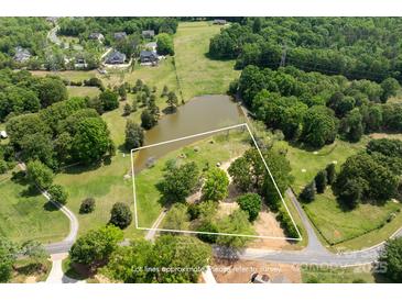 Expansive aerial view of lot with pond; lot lines are approximate, please refer to survey at 8805 Wingard Dr, Waxhaw, NC 28173
