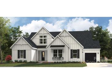 Charming two-story white farmhouse with black trim, a tidy lawn, and a window flower box at 8805 Wingard Dr, Waxhaw, NC 28173