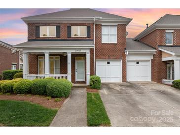 Charming brick home with a welcoming front porch and a two-car garage at 20015 N Cove Rd, Cornelius, NC 28031