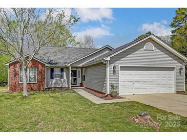 Charming single-Gathering home with brick and vinyl siding, a well-maintained lawn, and an attached two-car garage at 239 Bradford Glyn Dr, Mooresville, NC 28115