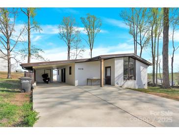 Charming single-story home featuring a stylish carport, modern windows, and a well-manicured front yard at 403 Greenbriar S Rd, Statesville, NC 28625