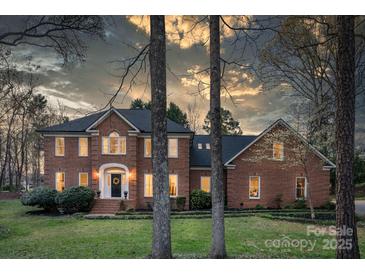 Charming brick two-story home with manicured lawn, elegant entryway, and inviting curb appeal at 5750 Hemby Rd, Matthews, NC 28104