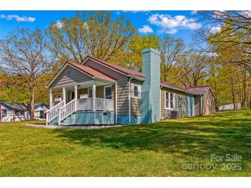 Charming home with a welcoming front porch, lovely lawn, and cozy aesthetic at 612 Rowan Mill Rd, Salisbury, NC 28147