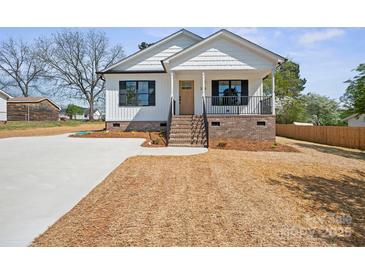 Charming home with a brick foundation, inviting porch, and newly laid lawn at 203 E 27Th St, Kannapolis, NC 28083